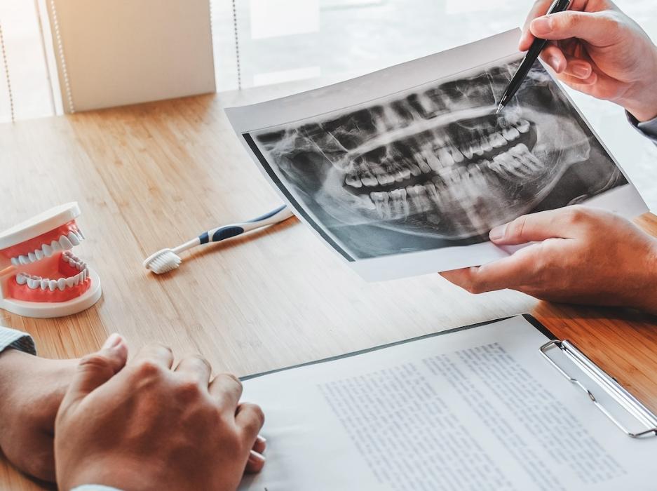 A dentist showing a patient their xrays