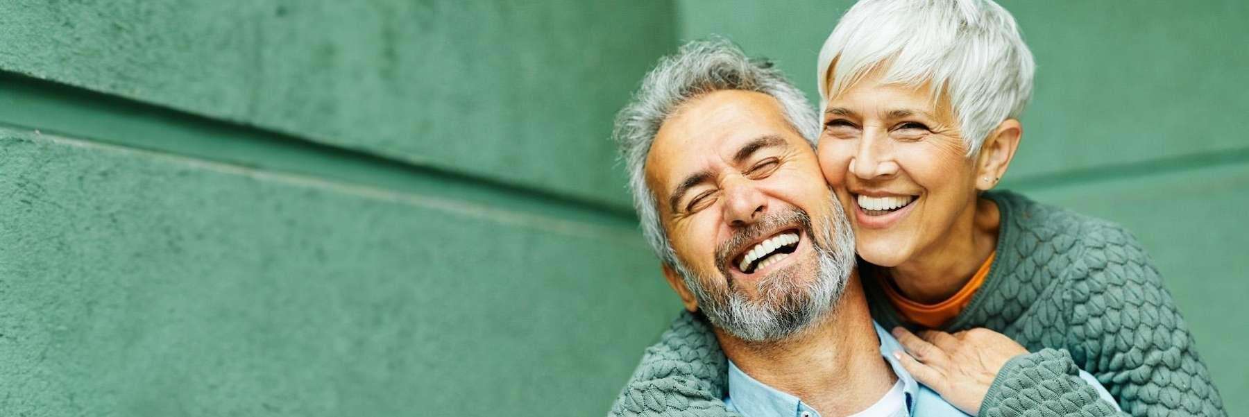 Couple smiling with implants in Brooklyn