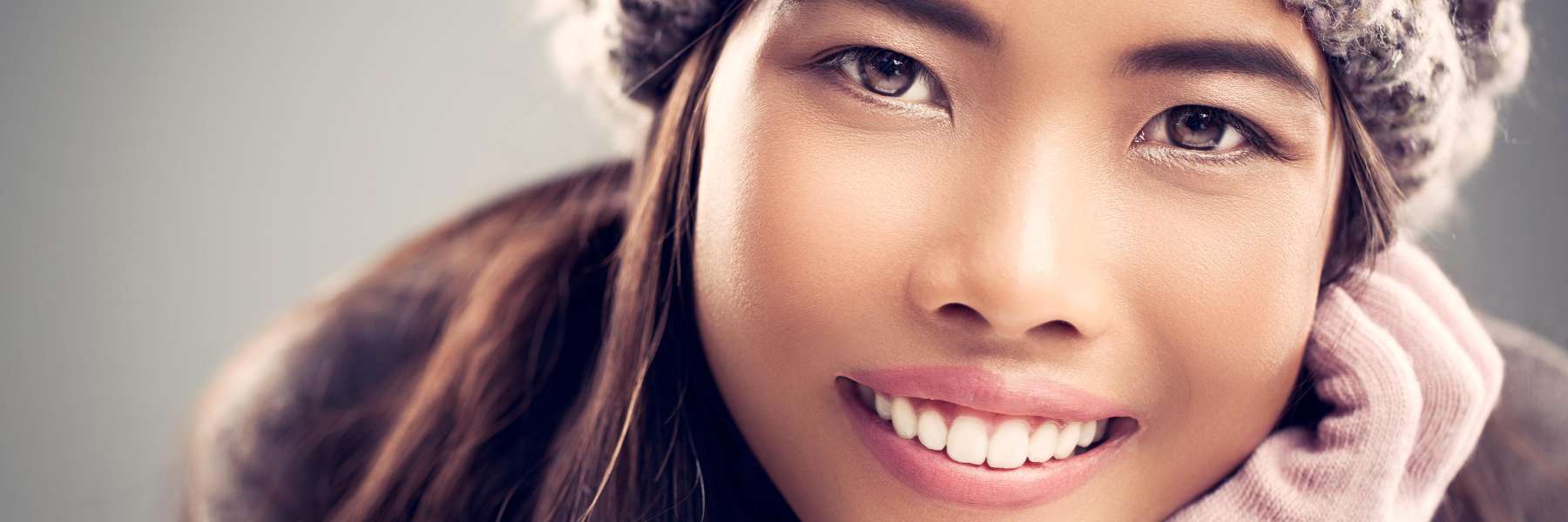 woman in snow hat smiling | dentist brooklyn