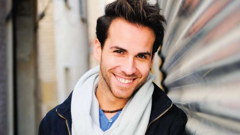 man in scarf smiling outside | dental crowns 11201
