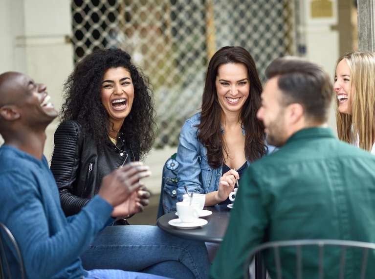 A group of friends laughing over coffee