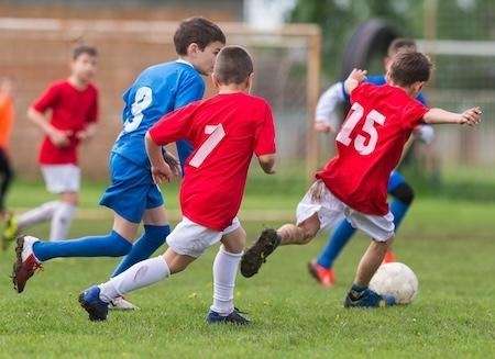 A group of kids playing soccer