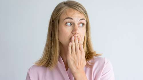A woman that is surprised after cracking a tooth