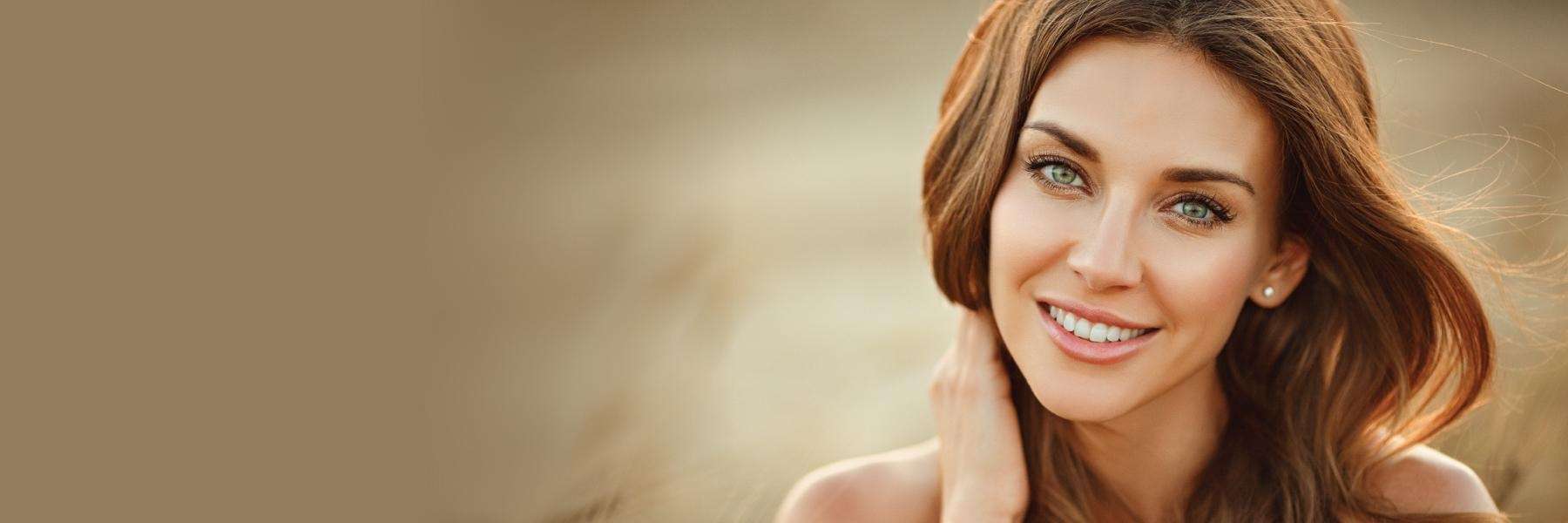 woman with brown hair smiling | cosmetic dentist 11201